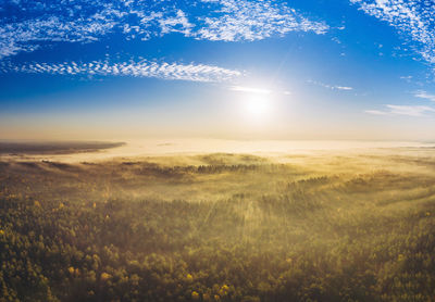 Scenic view of field against bright sky