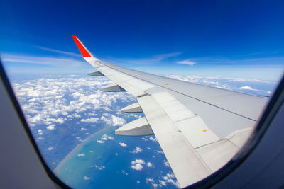 Aerial view of airplane flying in sky