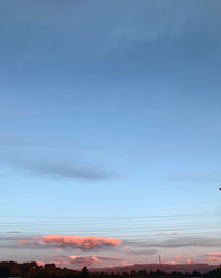 Low angle view of cables against blue sky