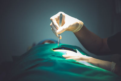 Cropped hands of surgeon performing surgery