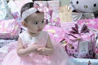 High angle view of girl sitting against gifts during birthday