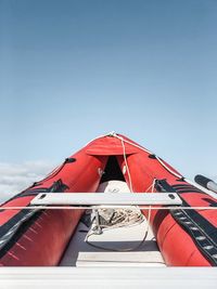 Low angle view of red boat against sky