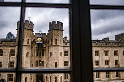 Clock on building seen through window