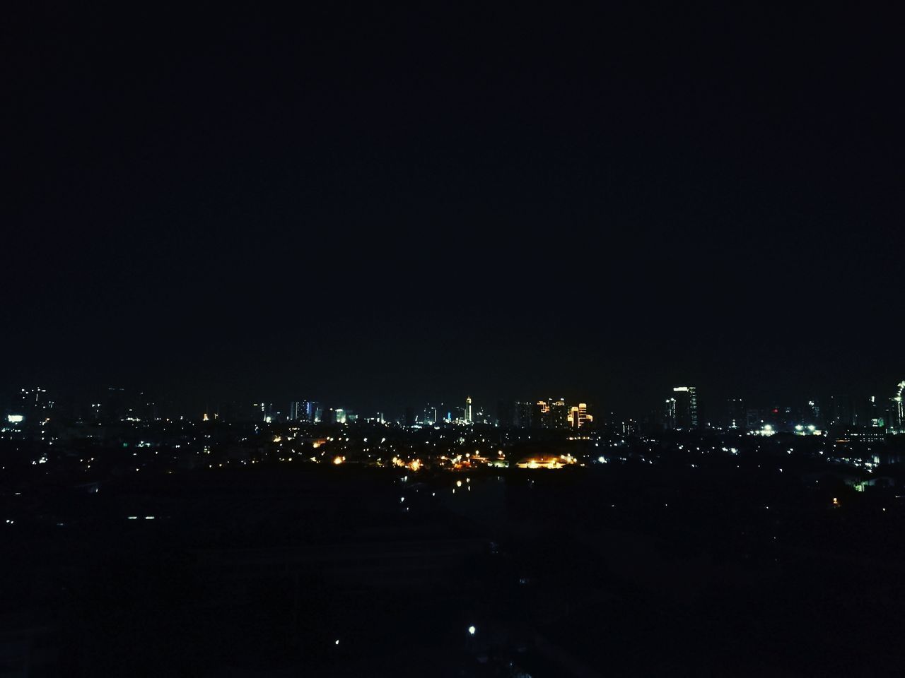 ILLUMINATED BUILDINGS AGAINST SKY AT NIGHT