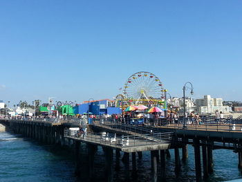 Ferris wheel against clear blue sky