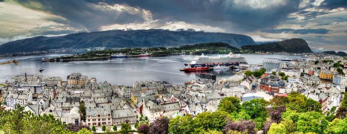 High angle view of townscape by sea against sky