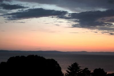 Scenic view of sea against romantic sky at sunset