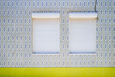 Closed windows on patterned wall