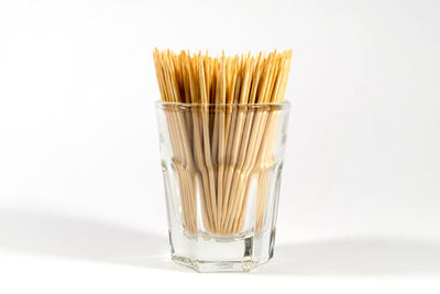 Close-up of wineglass against white background