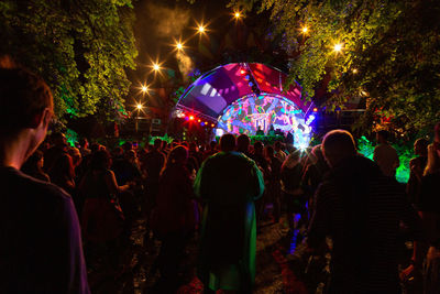 People enjoying music concert at night