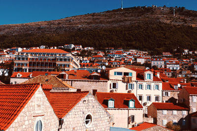 Houses in town against sky