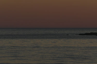 Scenic view of calm sea at sunset
