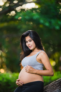 Portrait of a beautiful young woman standing outdoors