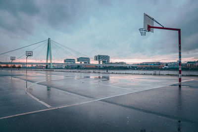 View of wet airport runway against sky