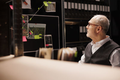 Side view of businessman using digital tablet in office