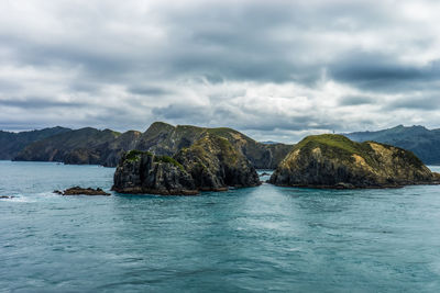 Scenic view of sea and mountains against sky