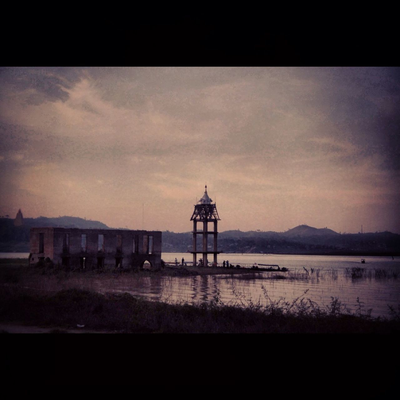 built structure, architecture, water, building exterior, sky, sunset, transfer print, silhouette, auto post production filter, lighthouse, scenics, tranquility, sea, tower, travel destinations, tranquil scene, cloud - sky, nature, dusk, beauty in nature