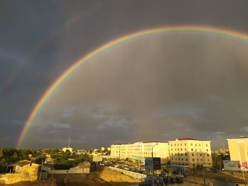 Rainbow over city buildings