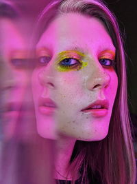 Close-up portrait of woman in neon lights