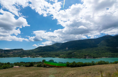 Scenic view of lake and mountains against sky