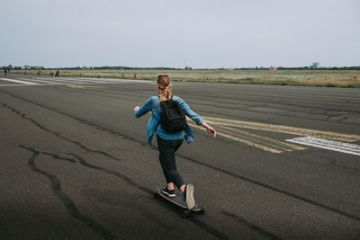 Full length of woman on road against sky