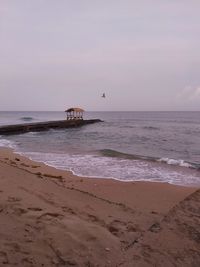 Scenic view of beach against sky during sunset