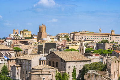 Buildings in town against sky