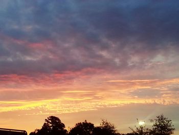 Low angle view of cloudy sky at sunset