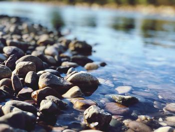 High angle view of pebble stones in river