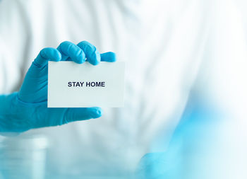 Midsection of man with text on hand