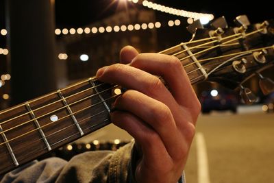 Close-up of man playing guitar