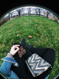 Rear view of girl sitting on grass