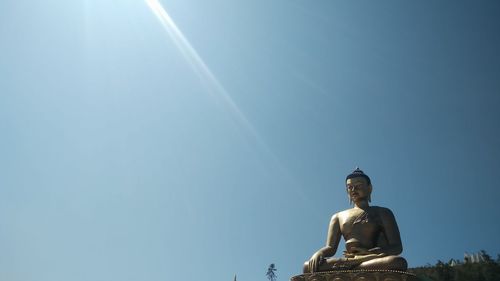 Low angle view of statue against sky