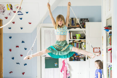 Girl doing splits while hanging  barefoot