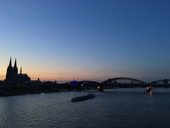 View of bridge over river against clear sky