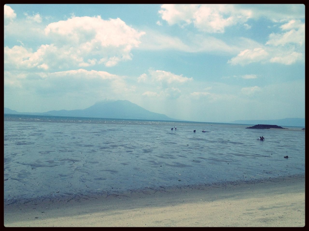 transfer print, sea, water, sky, beach, auto post production filter, scenics, tranquil scene, cloud - sky, tranquility, beauty in nature, shore, sand, horizon over water, nature, cloud, cloudy, coastline, idyllic, mountain