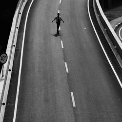 High angle view of man walking on bridge