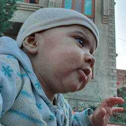 Close-up portrait of cute girl looking away