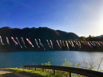 Scenic view of lake against clear blue sky