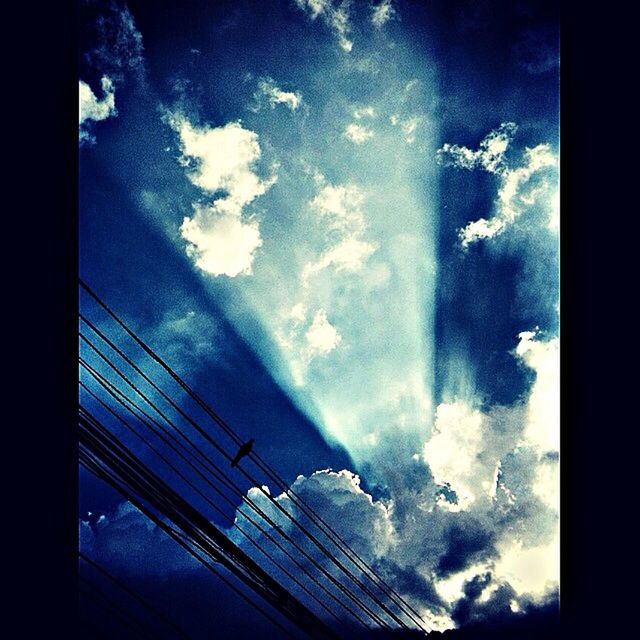 low angle view, sky, cloud - sky, cloudy, cloud, transportation, built structure, architecture, silhouette, connection, mode of transport, auto post production filter, glass - material, no people, outdoors, day, reflection, nature, power line, tilt