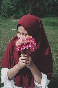 Midsection of woman holding flower bouquet