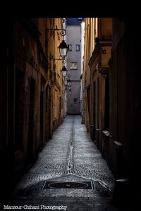 Empty alley amidst buildings