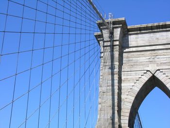 Low angle view of bridge against clear blue sky