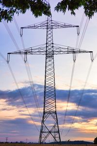 Low angle view of electricity pylon against sky