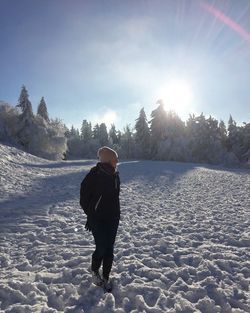 Woman standing on snow covered landscape