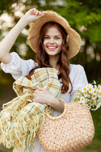 Portrait of young woman sitting on hammock