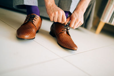 Low section of man wearing shoes