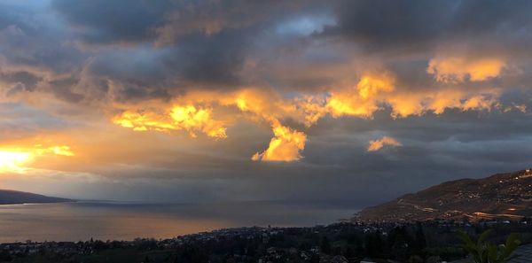 Scenic view of dramatic sky over mountain during sunset