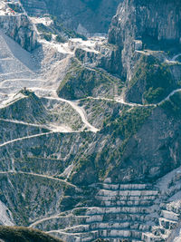 View of the carrara marble quarries and the transport trails carved into the side of the mountain.