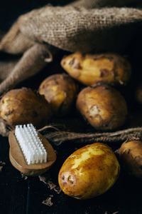 Close-up of brush potatoes on table